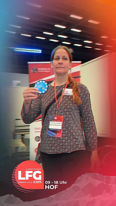 Für die Fachstelle Glücksspielsucht Hof war unsere Kollegin Ute Hofmann-Gützlaff gemeinsam mit einem Kollegen (Markus Schöfthaler) von der Psychologischen Beratungsstelle (Erziehungsberatung) der Diakonie Hochfranken am 24.05.26 auf der LFG Con in der Hofer Freiheitshalle.

Der Aufbau begann um 07:00 Uhr, von 09:00 bis 18:00 Uhr war die Halle für Besucher:innen geöffnet.

Neben zahlreichen Möglichkeiten, Spiele auszuprobieren und im Merchandise-Angebot zu stöbern, wurde ein abwechslungsreiches Bühnenprogramm geboten: Talkrunden, Live-Turniere, ein Cosplay-Contest mit Siegerehrung sowie Grußworte und eine Podiumsdiskussion mit Landrat Oliver Bär, Oberbürgermeister Stefan Schmalfuß, Digitalminister Dr. Fabian Mehring und Vertreter:innen von GamesMarkt. Auch Bundesministerin Dorothee Bär war vor Ort.

Am Messestand ergaben sich viele  Gespräche – sowohl mit Netzwerkpartnern aus dem Präventionsbereich als auch mit zahlreichen interessierten Besucherinnen und Besuchern. Gamer, Influencer, Cosplayerinnen und Cosplayer sowie Begleitpersonen kamen über die Mitmach-Aktionen schnell mit den Fachkräften ins Gespräch.

Eine Demokratiesäule stellte die Frage „Was zockst du?“ (A: Gaming, B: Gambling, C: Beides). Ergänzend gab es eine Bodenplane („Macht Gaming glücklich?“) sowie die Möglichkeit zu einem Online-Selbsttest zum Medienverhalten.

Inhaltlich ging es um die Arbeit der Fachstelle, die Verknüpfung von Gaming und Gambling, Suchtentwicklung und grundsätzliche Fragen wie „Was ist Glück?“.

Besonders beeindruckt zeigte sich Ute von einem Familienvater, der von früherem Suchtverhalten berichtete: „Meine Freundin war zu Besuch und ich saß nur am PC. Irgendwann ist sie gegangen – und ich habe es nicht einmal bemerkt. Da wusste ich, dass ich etwas ändern muss.“

Ein Highlight war der Besuch von Landrat Oliver Bär und Bundesministerin Dorothee Bär, die am Stand vorbeikamen und sich aktiv beteiligten.

Mit bestem Dank an https://www.instagram.com/ufx_media für das tolle Video.